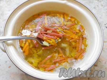 Когда картофель будет почти готов, добавить в кастрюлю обжаренные с колбасой овощи.