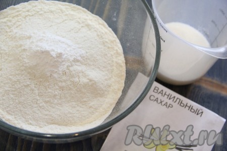 В объёмную миску всыпать 300 грамм просеянной муки, добавить сахар, разрыхлитель и ванильный сахар, слегка перемешать.