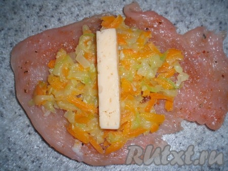 Сформировать рулетики: на каждый отбитый кусочек филе индейки выложить остывшую начинку, сыр, свернуть рулетом и скрепить зубочистками.