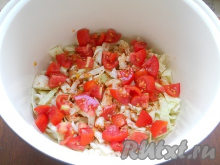 На слой капусты выложить половину нарезанных кубиками помидоров.
