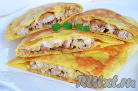 Не забываем достать зубочистки. Разрезаем мексиканские пшеничные лепешки с начинкой из фарша и грибов пополам, выкладываем на тарелку и подаем к столу горячими. Просто и очень вкусно!
