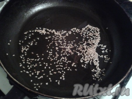 Подогреть сковороду с подсолнечным маслом, выложить кунжут и обжарить, помешивая. Когда кунжут станет слегка коричневым, снять его с огня.
