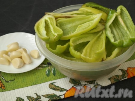 Болгарский перец нужно разрезать пополам и удалить семена. С острым перцем можете поступить на своё усмотрение: семена можно также удалить, а можно и оставить, тогда аджика будет более жгучей. Очистить чеснок.