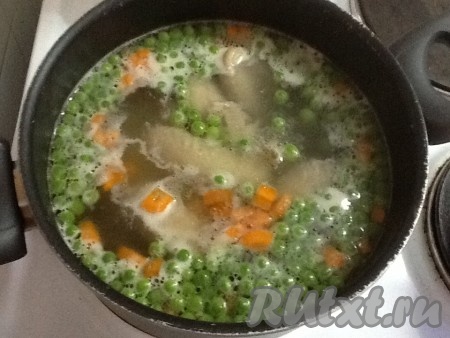 Туда же отправляем нарезанную морковь, доводим суп до кипения и варим на небольшом огне 10 минут.
