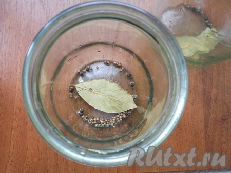 На дно чистых банок поместить по лавровому листу, кориандр и черный перец горошком.