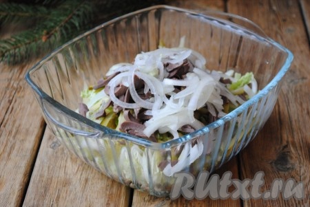 Очищенный лук нарезать полукольцами, обдать кипятком, чтобы убрать лишнюю горечь, а затем добавить в салат с куриными сердечками.&nbsp;
