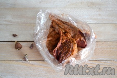 Обильно приправить кусочки гуся специями и солью, перемешать и выложить в рукав для запекания.
