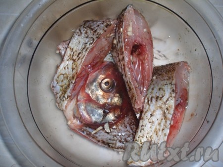 Рыбу почистить, вымыть, нарезать на порционные кусочки. Посолить, поперчить, добавить специи для рыбы. Сбрызнуть соком, выжатым из половинки лимона, и добавить выдавленный через пресс чеснок. Все перемешать и оставить мариноваться на пару часов.