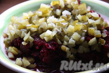 Соленые огурчики, нарезанные кубиками, выложить к натёртой свекле, перемешать салат.
