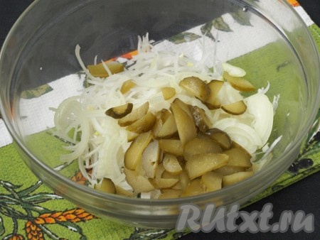 Лук нарезать тонкими полукольцами, маринованный огурчик - ломтиками и выложить к дайкону.
