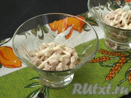 Вареное куриное филе, нарезанное кубиками, разложить по салатникам, немного посолить и смазать майонезом.