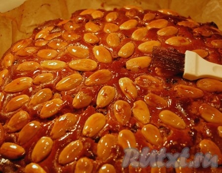 Отправить форму с тестом в заранее нагретую до 180 градусов духовку. Печь рождественский кекс с сухофруктами и орехами примерно 40-60 минут (или больше). Обязательно проверить готовность лучинкой (или зубочисткой). Готовый кекс вынуть из формы и смазать сахарным сиропом всю поверхность (для приготовления сиропа соединить в ковшике сахар и воду, довести до кипения и варить, помешивая, 3 минуты).