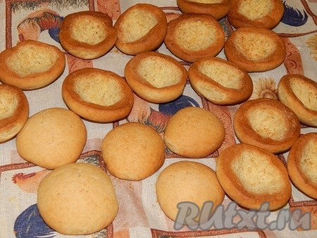 Достать готовую выпечку из духовки. Пока половинки наших будущих пирожных "Персики" ещё слегка горячие, с помощью маленькой ложечки или ножа с внутренней стороны из каждой половинки удалить часть мякоти, сделав небольшое отверстие. Дать половинкам полностью остыть.