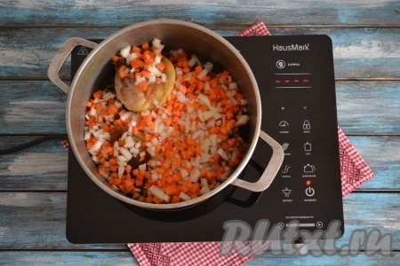 Лук и морковь нарезать мелкими кубиками размером, примерно, 5х5 мм. Можно морковь натереть на терке. Измельчить чеснок. Выложить морковь, лук и чеснок к обжаренным кусочкам утки, влить 3 стакана воды.&nbsp;
