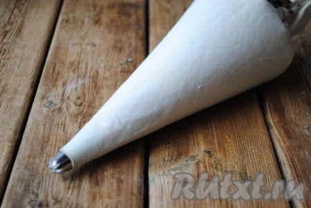 Наполнить кремом кондитерский мешок с насадкой.
