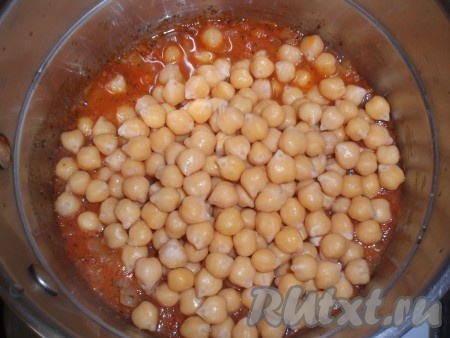 Затем выложить в томатный соус отваренный заранее нут, всыпать прованские травы, перемешать, тушить на маленьком огне 5 минут.
