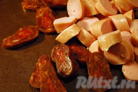 Когда горох сварится, отправим в кастрюлю нарезанные копченые колбаски с сосисками и морковь с луком, а также специи - лавровый лист, соль и перец. Гороховый суп нужно солить только после того, как сварится горох, иначе он останется жестким.