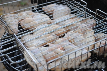 Решетку-гриль смазать немного растительным маслом и выложить на неё крылышки. 