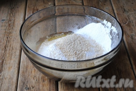 Частями добавить просеянную муку и кунжут, постепенно замешивая тесто.&nbsp;
