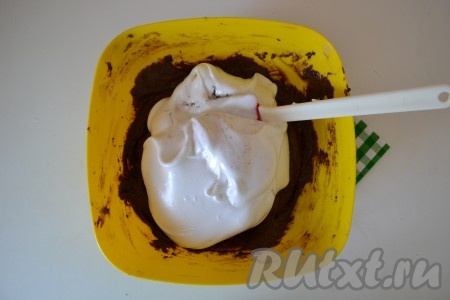 Белки взбить миксером в пышную массу. В тесто, непрерывно взбивая миксером, всыпать тонкой струйкой оставшиеся 70 грамм сахара, продолжать взбивать 5 минут на высокой скорости. Масса должна увеличиться в объёме в несколько раз и стать густой. Взбитые белки добавить в получившуюся массу, аккуратно перемешать тесто силиконовой лопаткой.
