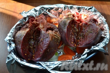 Затем сердце разрезать вертикально, но не до конца, посолить и хорошенько натереть специями. Поместить сердце в форму на овощи разрезами кверху.