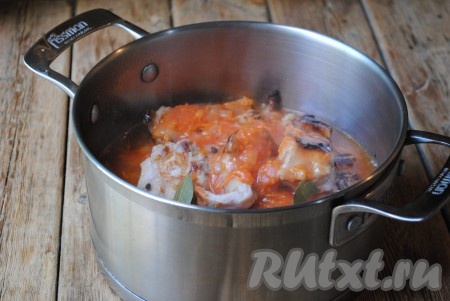 Томатную подливу вылить в кастрюлю с обжаренными кусочками кролика, влить воду, добавить душистый перец горошком и лавровые листья.&nbsp;
