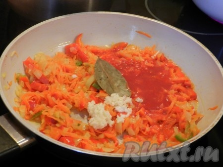 Приготовим зажарку. Лук, болгарский перец нарезать, морковь натереть на терке. Обжарить в сковороде на растительном масле, иногда помешивая.&nbsp; Посолить, поперчить, добавить измельченный чеснок, лавровый лист, томатный сок. Перемешать, накрыть крышкой, готовить на медленном огне минут 10-15, помешивая.
