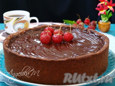 Утром я украсила пирог глазурью: молоко довела до кипения и добавила в него поломанный на кусочки шоколад, затем хорошо перемешала и сняла с огня. Достала пирог и залила его тёплой глазурью. Украсила ягодами клубники.
