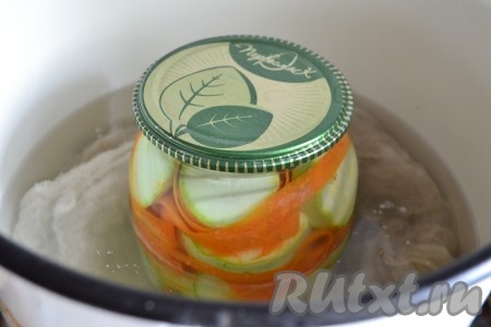 Накрыть банки стерилизованными крышками. В кастрюлю налить воду, поместить на дно тряпочку, сложенную в несколько раз, довести воду до кипения.&nbsp;Банки с кабачками аккуратно ставить в горячую воду (вода должна доходить до "плечиков" банки). Стерилизовать банки на среднем огне 15 минут с момента закипания.&nbsp;
