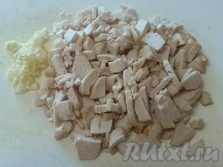Остывшее жареное куриное мясо мелко нарезать, чеснок порубить ножом.