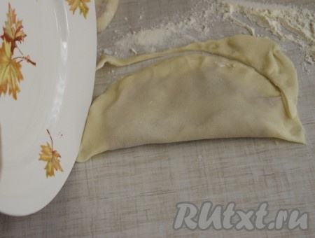 Берем блюдце или небольшую тарелку и по кругу отрезаем лишние края теста тарелкой.
