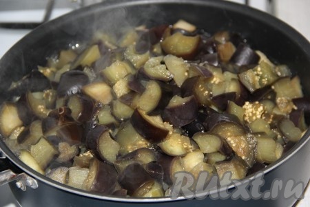 В сковороду с высокими бортиками влить растительное масло, поставить на огонь и разогреть. Аккуратно с помощью шумовки выложить баклажаны в сковороду.