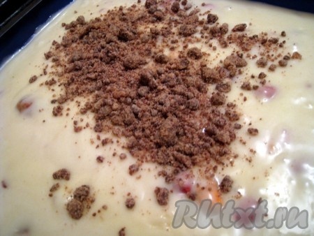 Форму для выпечки смазать подсолнечным маслом (если будете выпекать в силиконовой форме, тогда маслом её можно не смазывать), выложить тесто. Форму для выпечки нужно заполнять тестом не более, чем на 2/3 объёма (кекс в процессе выпечки поднимается примерно в 1,5-2 раза). Равномерно посыпать тесто сверху подготовленной шоколадной крошкой - штрейзелем.