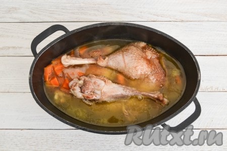 Влить воду и поставить на огонь. В момент закипания снизить огонь к минимуму, накрыть крышкой и оставить тушиться кусочки гуся на 45-55 минут.
