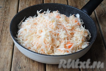 Когда лук станет мягким, выложить к луку квашеную капусту, отжатую от рассола. Я использовала квашеную капусту домашнего приготовления. 