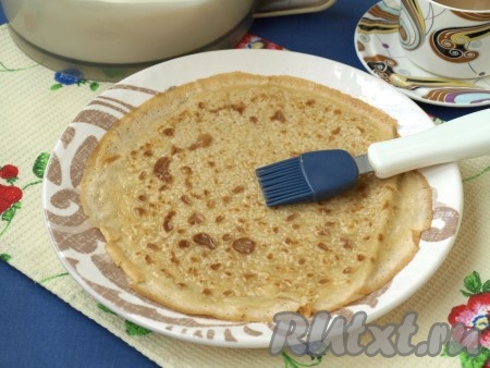 На плоскую тарелку выложить первый блинчик и с помощью кисточки смазать его кофейной жидкостью. Подождать, пока кофе впитается.
