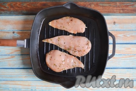 Хорошо разогреть сковороду гриль на сильном огне, затем уменьшить огонь до среднего. Смазать растительным маслом сковороду, пользуясь силиконовой кисточкой. Вливать масло не нужно! Выложить куриное филе. Обжарить с одной стороны в течение 1,5-2 минут, при этом немного прижимая каждый кусочек или прессом, или лопаткой.

