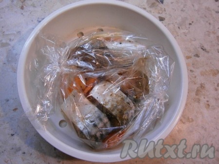 Поместить пакет с овощами и скумбрией в чашу мультиварки для варки на пару.
