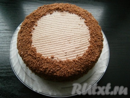 Отправить торт "Пражский" в холодильник на 1 час, после чего бока обсыпать крошкой, захватывая немного и верх торта (как на фото).
