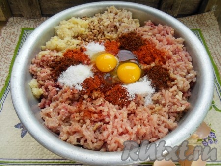 В получившийся фарш добавьте яйца, соль по вкусу, молотый лавровый лист, паприку и сухую аджику, перемешайте.
