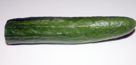 Нарежем небольшими кубиками огурец, очищенный от кожуры.