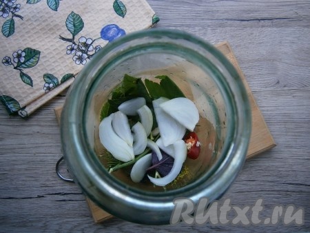 Лук очистить и нарезать полукольцами или перьями. Треть лука выложить в банку.

