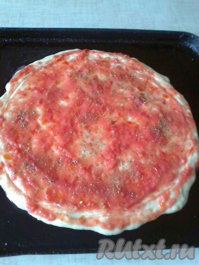 На тесто ровным слоем выкладываем приготовленное томатное пюре, посыпаем 0,5 чайной ложки итальянских трав.