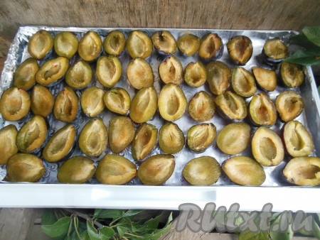 Стеклянную доску или поднос застелите фольгой, выложите половинки слив без косточек в один слой.&nbsp;
