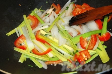 Разогреть сковороду вок, в раскаленное масло отправить перец сладкий, лук репчатый и лук порей. Обжаривать 2 минуты.