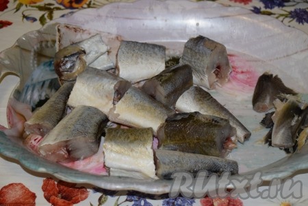 Размороженную навагу очищаем от чешуи. У данного вида рыбы чешуя очень мелкая, она легко счищается при помощи ножа. Удаляем голову, плавники и хвост. Очищенную рыбу потрошим и промываем. Нарезаем рыбу на порционные кусочки.
