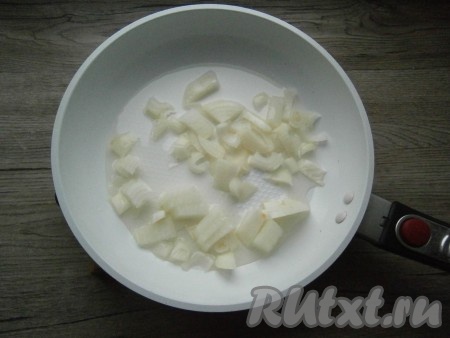 В другую сковороду влить оставшиеся 2 столовые ложки масла, выложить очищенный и нарезанный не крупно репчатый лук.
