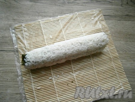 И медленно, аккуратно, помогая циновкой, свернуть все в плотненький рулет. Если все сделано правильно, получится красивый длинный рулет с плотно прилегающим рисом.
