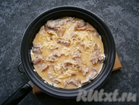Залить бекон яично-сырной смесью, огонь сделать минимальным, сковороду накрыть крышкой.