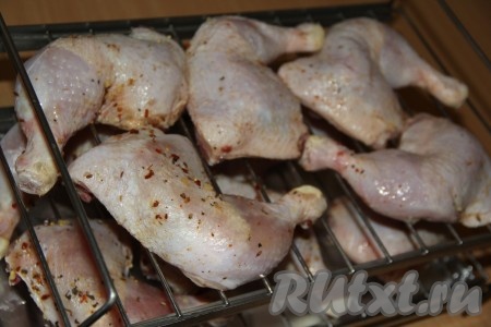 Подготовить домашнюю коптильню. Предварительно замочить в воде щепу. Я заливаю водой щепу прямо в пакете, а через полчаса протыкаю пакет в нескольких местах, чтобы ушла вода. Затем щепу равномерно раскладываю по дну коптильни. Потом выкладываю лист фольги поверх щепы, предварительно сделав 8-10 отверстий в фольге. После того как подготовили коптильню, можно выложить окорочка (не плотно к друг другу) на решётку. У меня получилось разложить 10 окорочков на двух решётках.